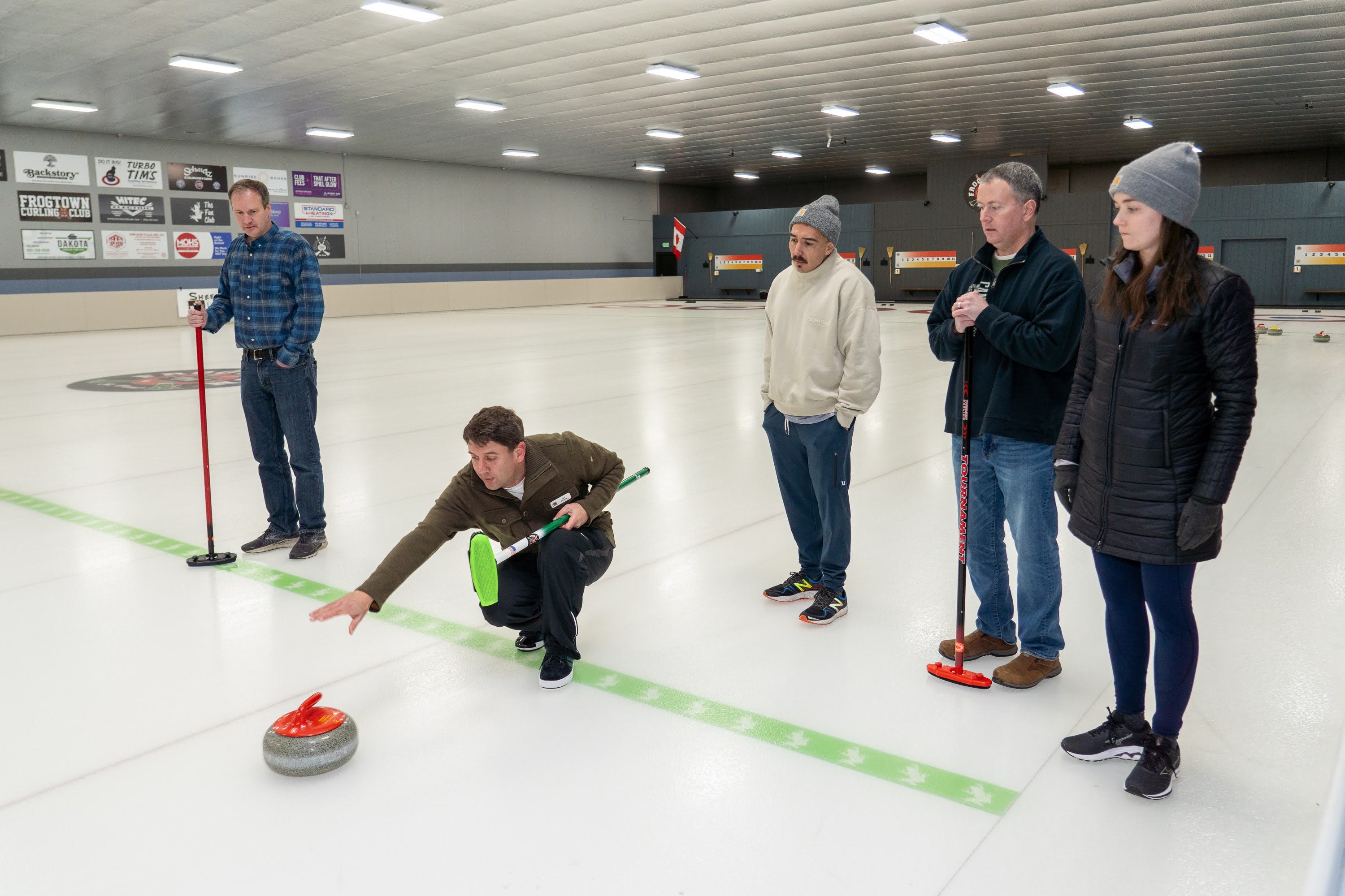 A group learning to deliver a curling stone at Frogtown