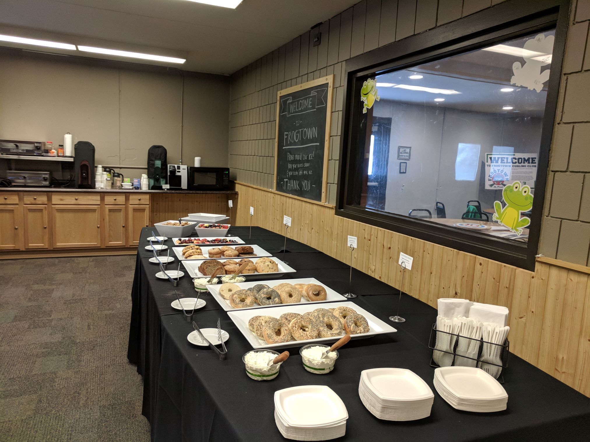 Food laid out on a long table in the Frogtown club room